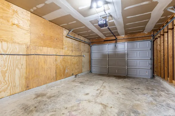 a view of a backyard with wooden fence