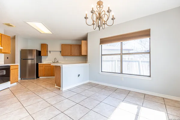 a kitchen with a refrigerator a sink and cabinets