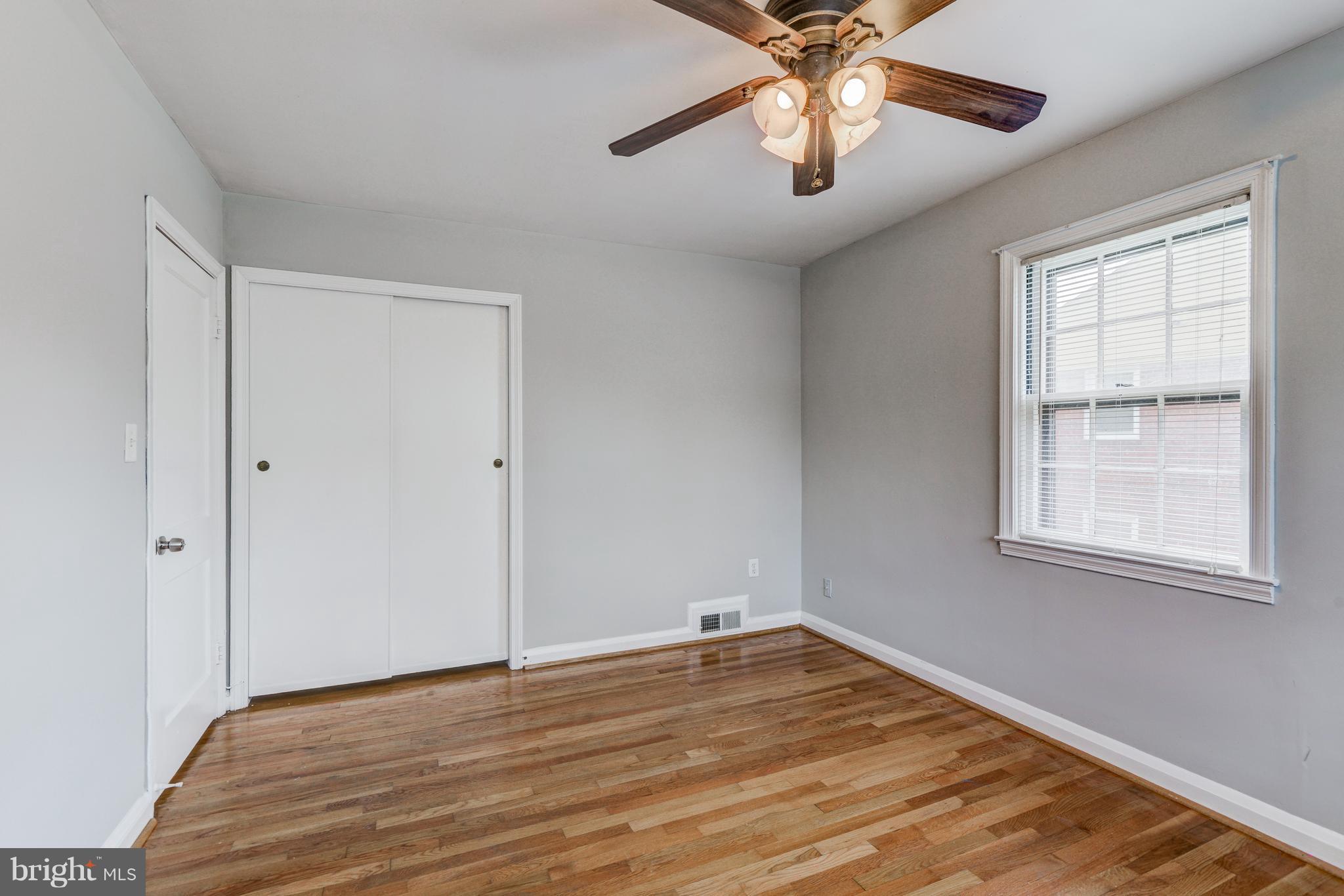 1265 Cedarcroft Road Baltimore, MD 21239 - Photo 15 of 21 a view of empty room with wooden floor and fan