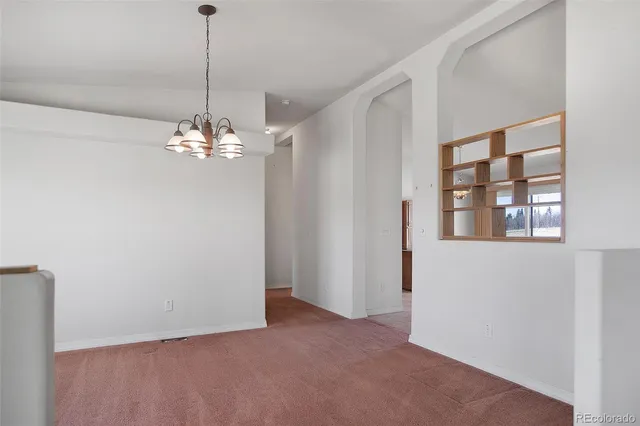 a view of a chandelier in big room and chandelier