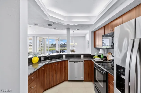 a kitchen with stainless steel appliances granite countertop a sink and stove