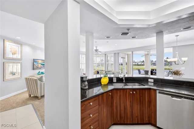 a kitchen with a sink a counter space and stainless steel appliances