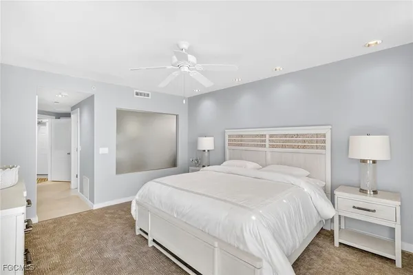 a bedroom with a bed and a lamp