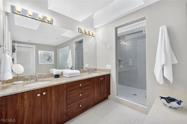 a bathroom with a sink double vanity and a shower