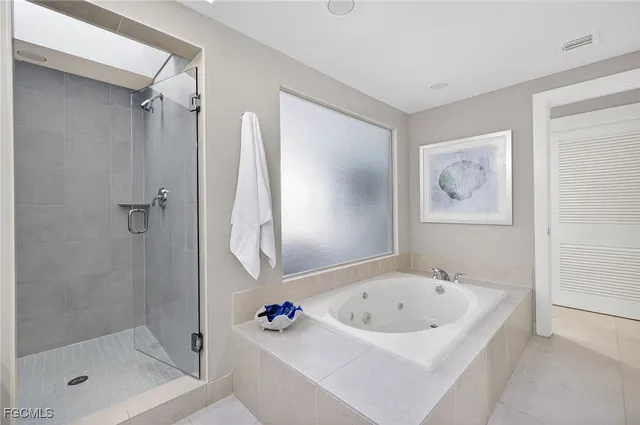 a bathroom with a tub and shower