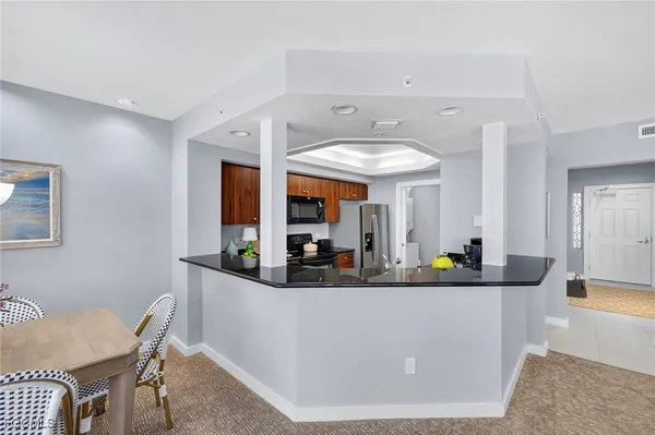 a view of a dining room with furniture and a chandelier