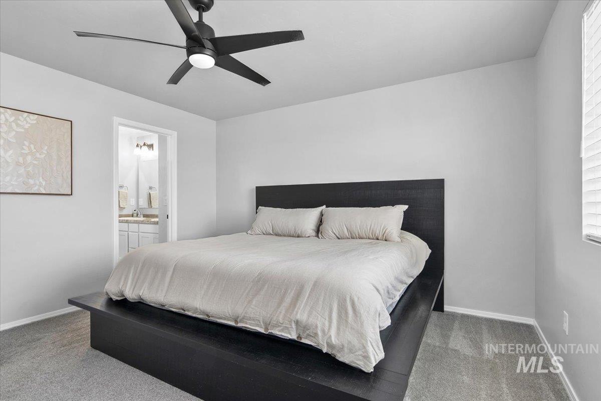13520 Farwell Street Caldwell, ID 83607 - Photo 20 of 26 Bedroom featuring ceiling fan, light colored carpet, and ensuite bathroom