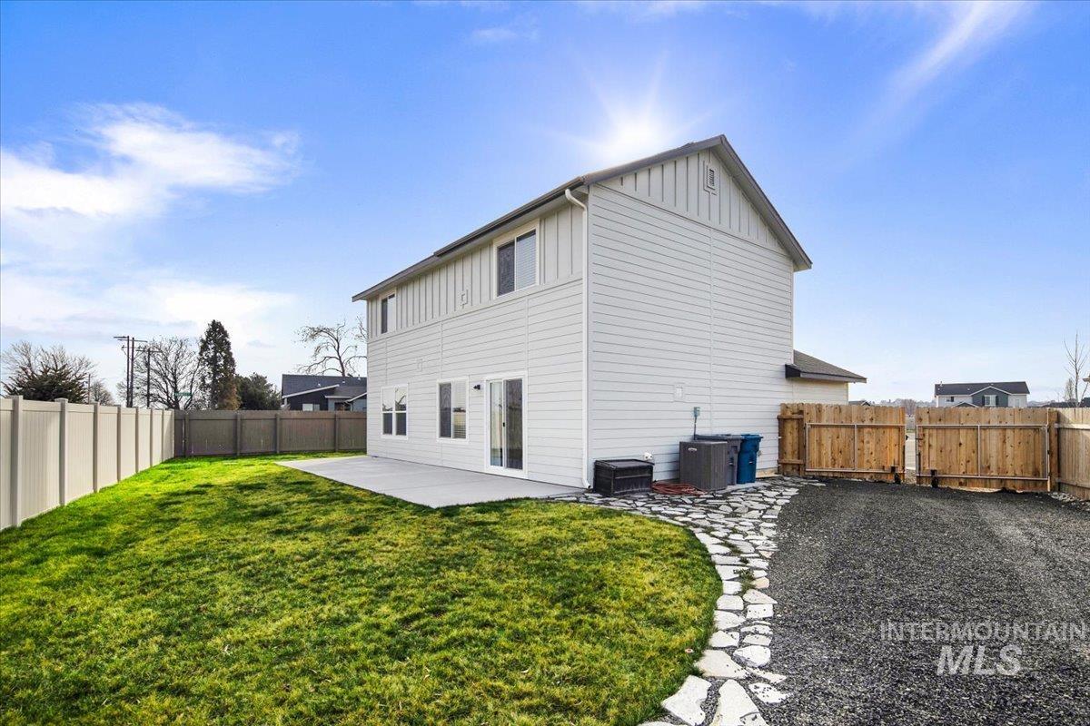 13520 Farwell Street Caldwell, ID 83607 - Photo 25 of 26 Back of property featuring a patio area, a fenced backyard, board and batten siding, and a gate