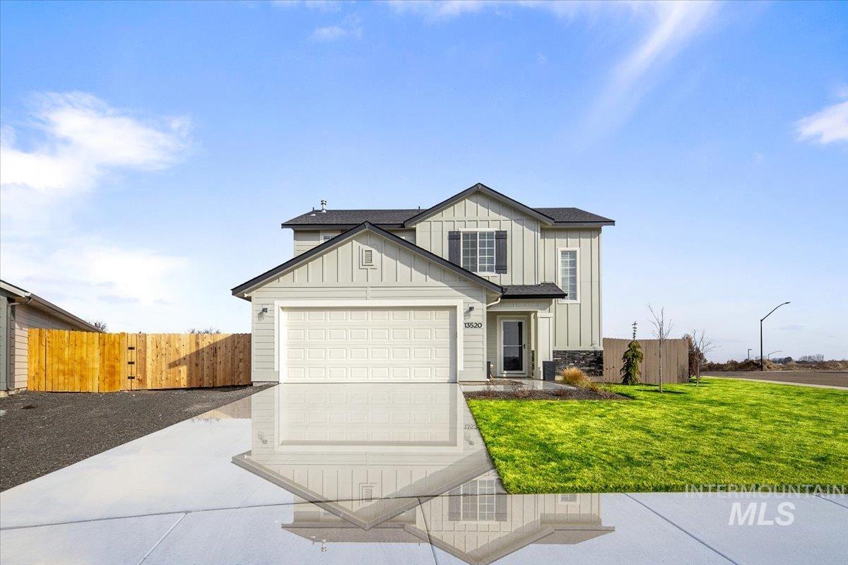 13520 Farwell Street Caldwell, ID 83607 - Photo 3 of 26 View of front of house featuring board and batten siding, driveway, and an attached garage