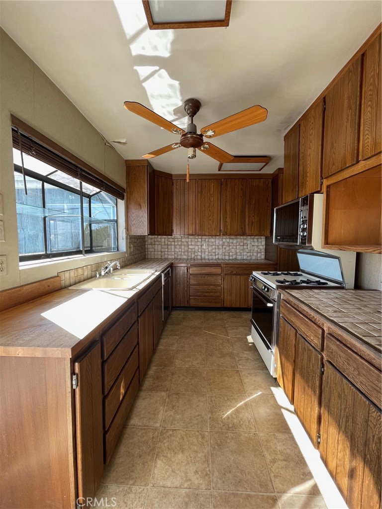 2004 Ripley Avenue Redondo Beach, CA 90278 - Photo 7 of 18 a kitchen with stainless steel appliances granite countertop a sink counter space cabinets and a large window