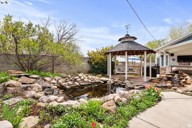 141 North 600 East Mapleton, UT 84664 - Photo 29 of 44 Fenced backyard featuring a small pond, a patio, and a gazebo