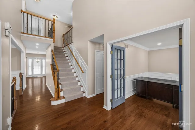 a view of entryway with wooden floor and stairs