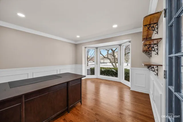 a hallway with a large window and wooden floor