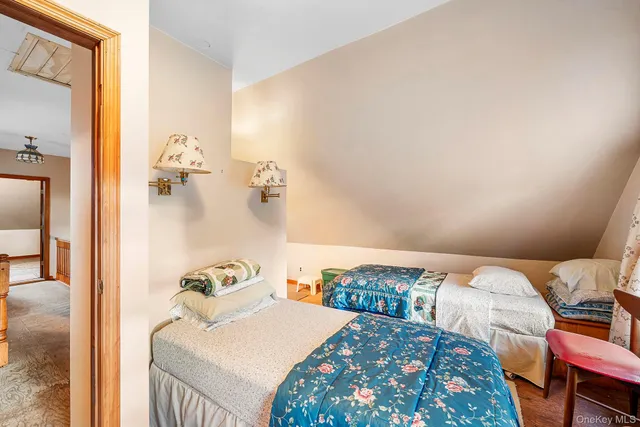 a view of a bedroom with bed and workspace