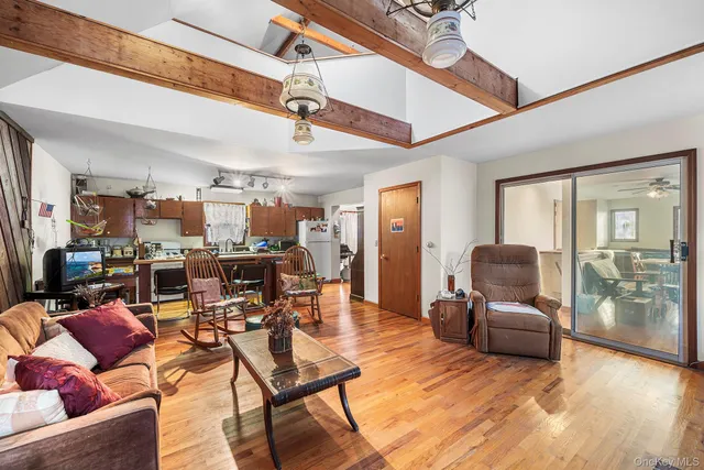 a living room with lots of furniture and a large window