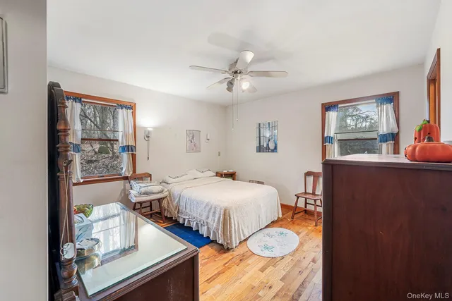 a bedroom with two beds and painting on the wall