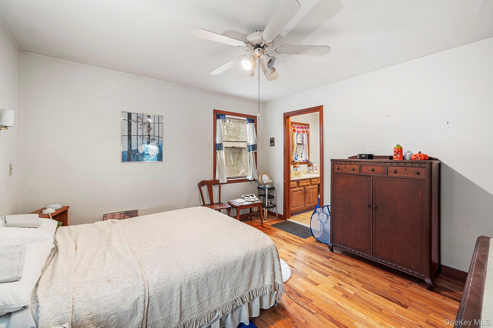 290 Ridge Road Campbell Hall, NY 10916 - Photo 8 of 26 a bed room with a bed mirror and a chandelier