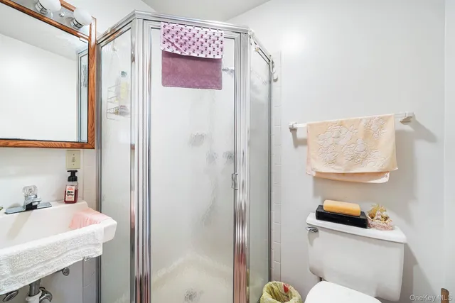 a bathroom with a sink a toilet and shower curtain