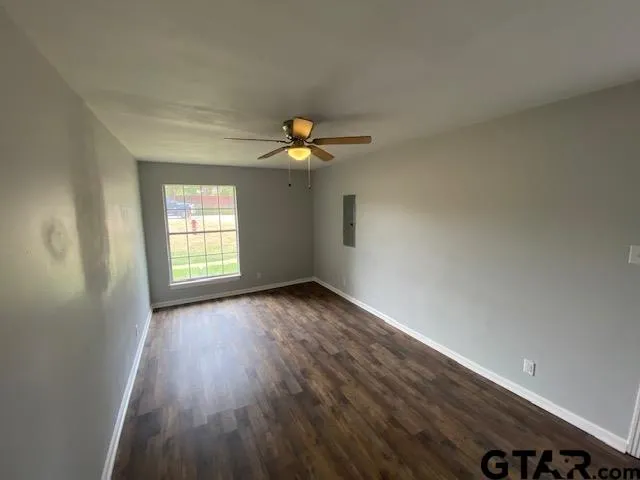 wooden floor in an empty room with a window