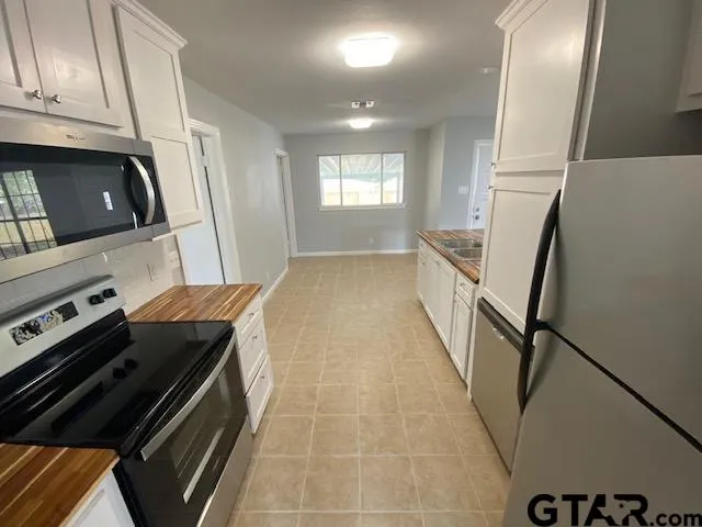a kitchen with a stove a sink and a refrigerator