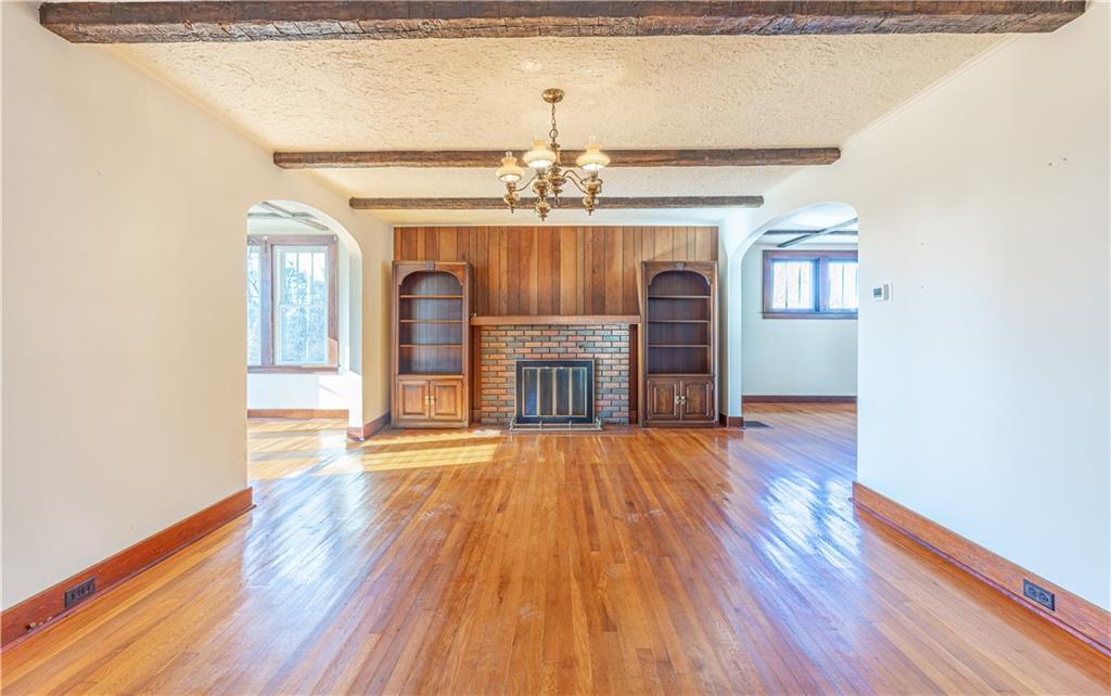 422 New Castle Road Butler, PA 16001 - Photo 3 of 27 a view of empty room with wooden floor and fireplace