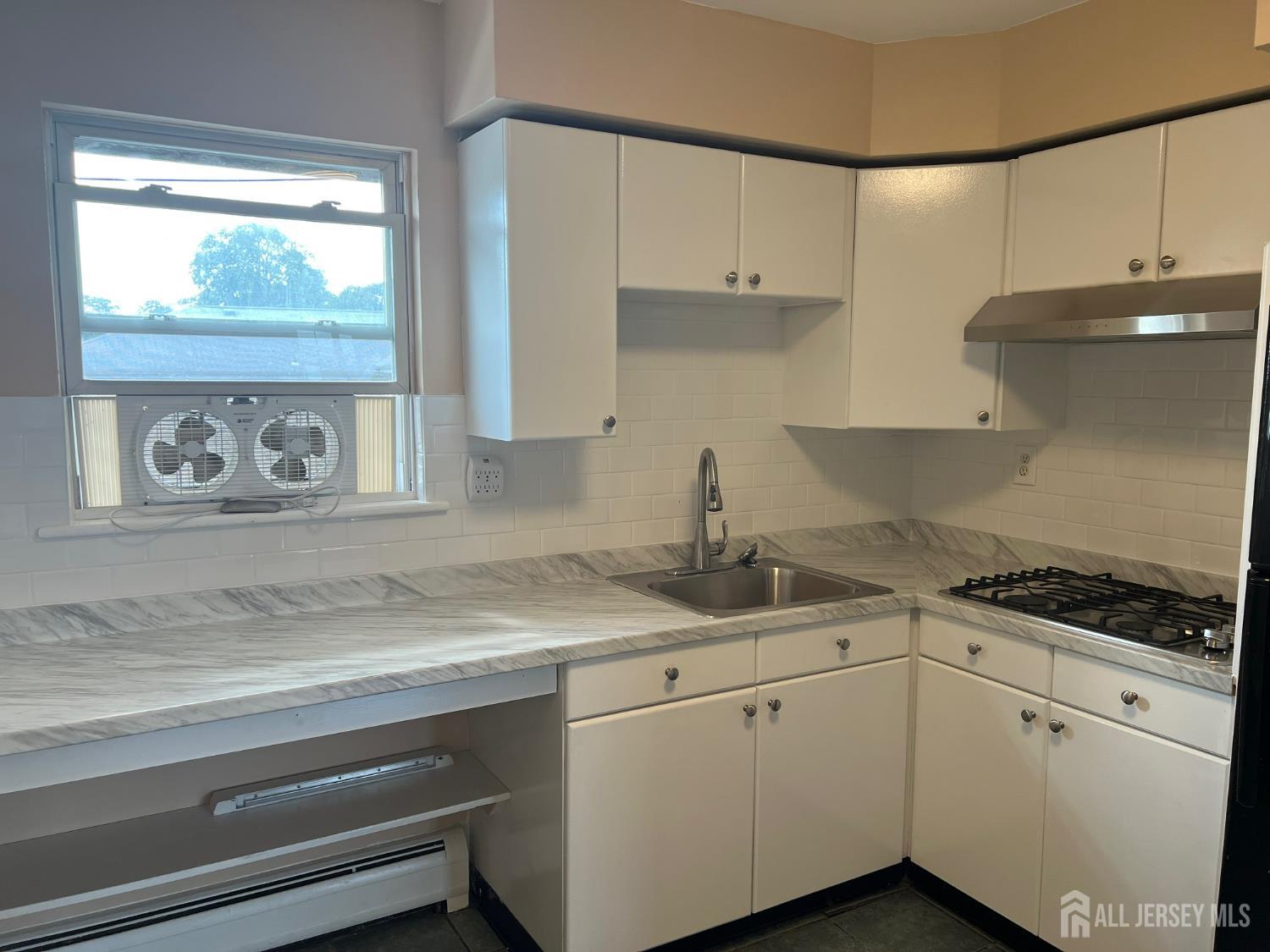 19A Gramercy Gardens Place Middlesex, NJ 08846 - Photo 3 of 8 a kitchen with granite countertop white cabinets and white appliances