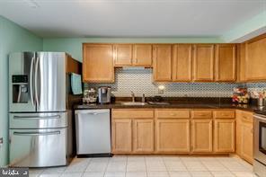 17 Devon Court Sterling, VA 20165 - Photo 11 of 30 a kitchen with stainless steel appliances granite countertop a refrigerator sink and cabinets