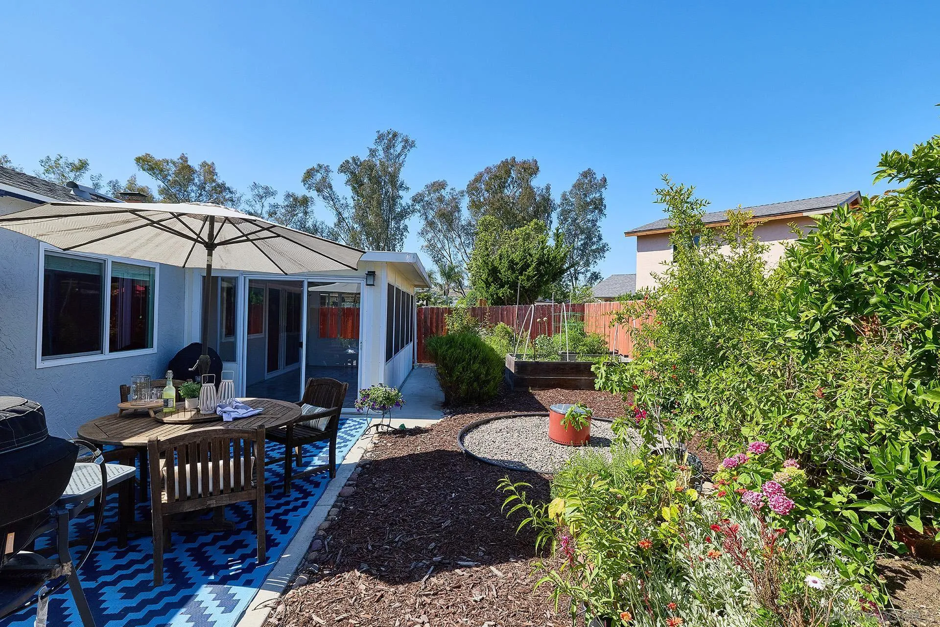 12835 Reo Real Drive Poway, CA 92064 - Photo 15 of 46 a view of a house with backyard sitting area and garden