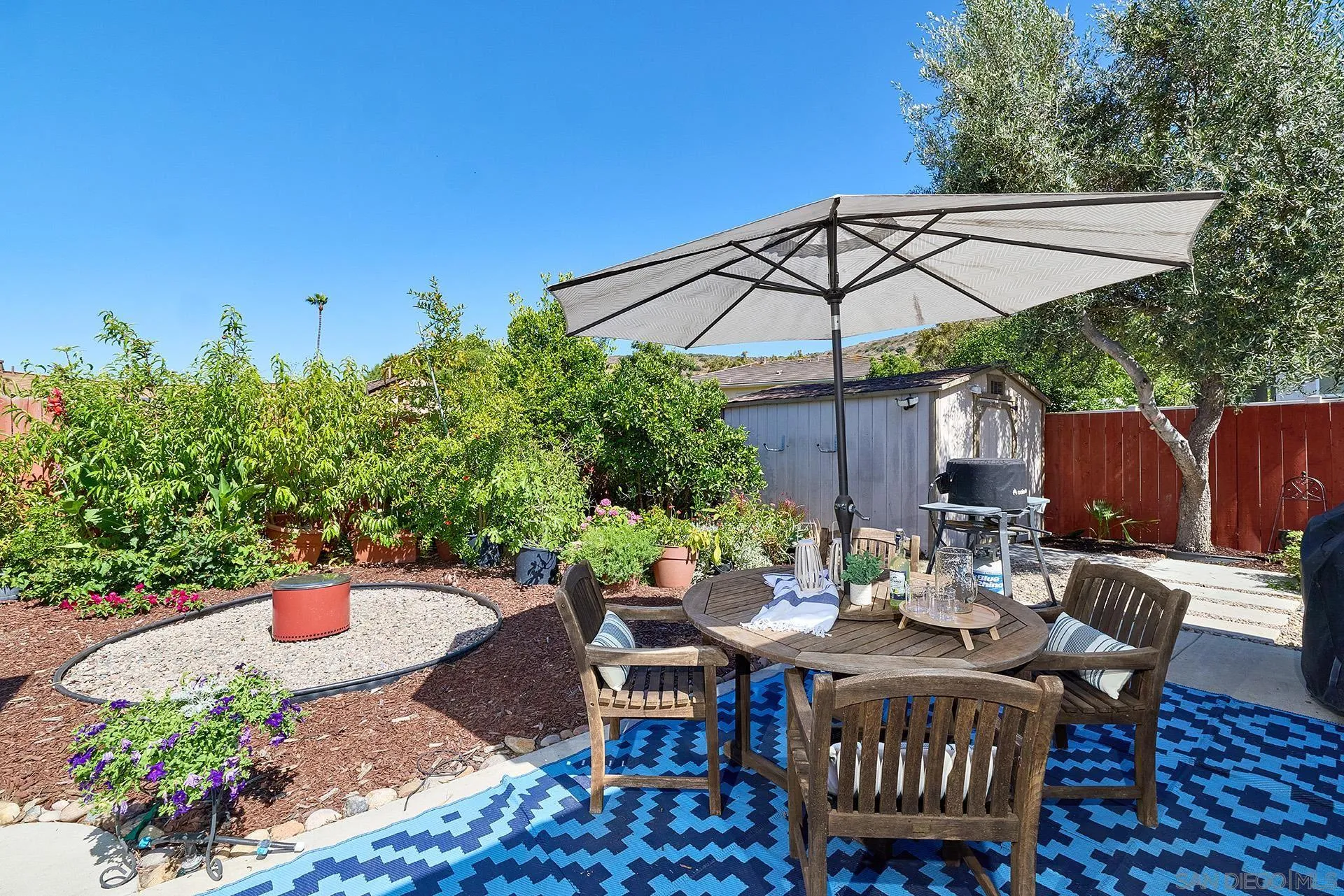 12835 Reo Real Drive Poway, CA 92064 - Photo 18 of 46 an outdoor space with furniture and umbrella