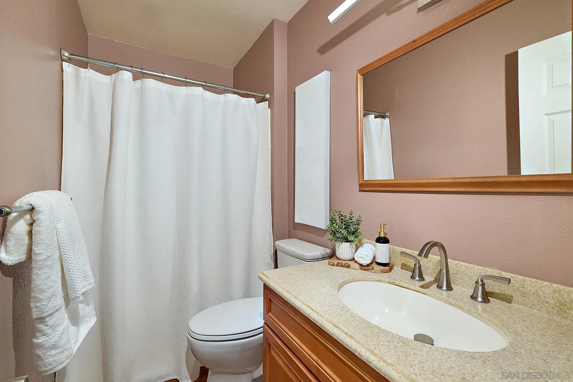12835 Reo Real Drive Poway, CA 92064 - Photo 27 of 46 a bathroom with a sink toilet and mirror