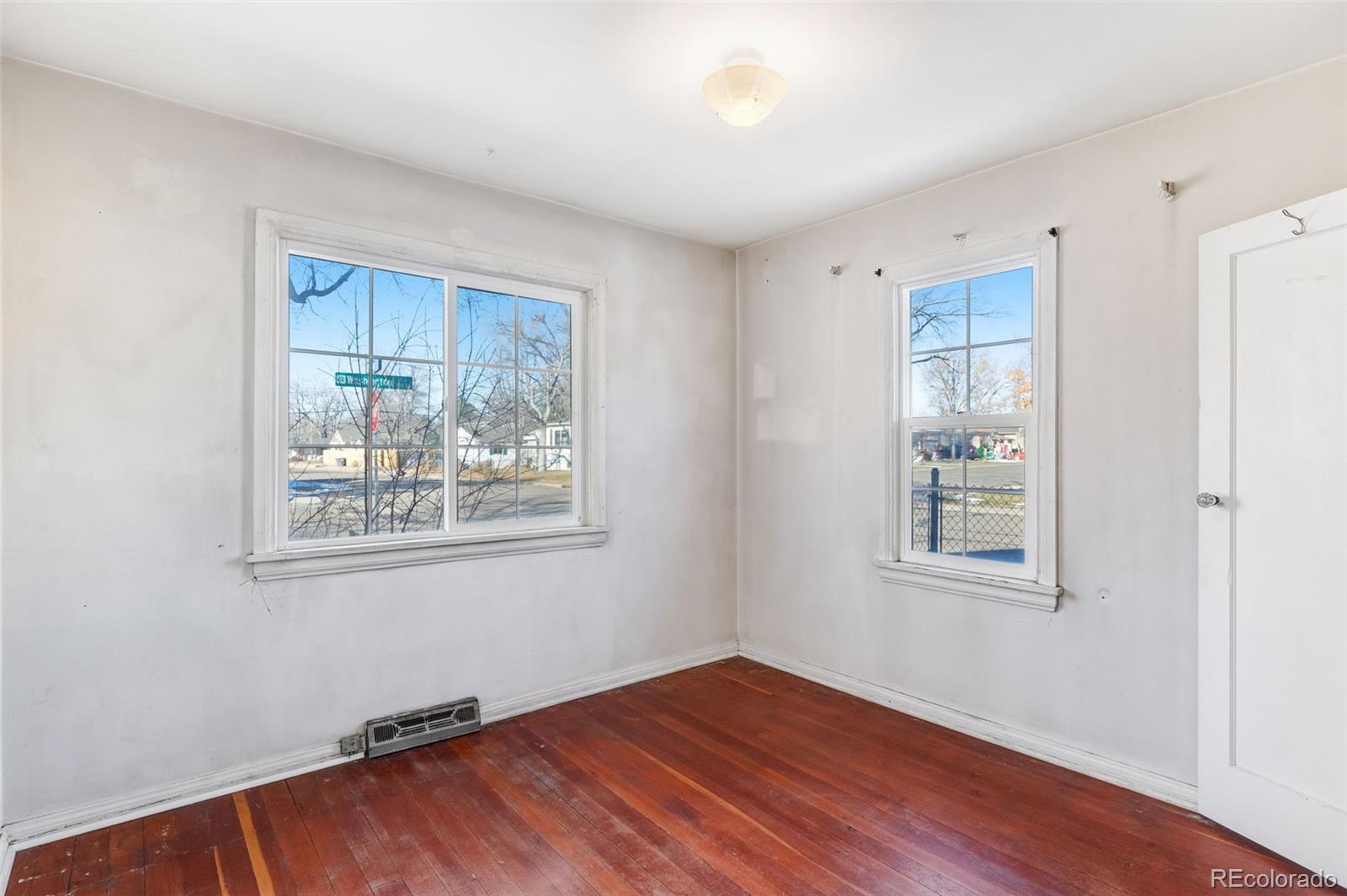 4500 South Washington Street Englewood, CO 80113 - Photo 17 of 30 a view of an empty room with wooden floor and a window