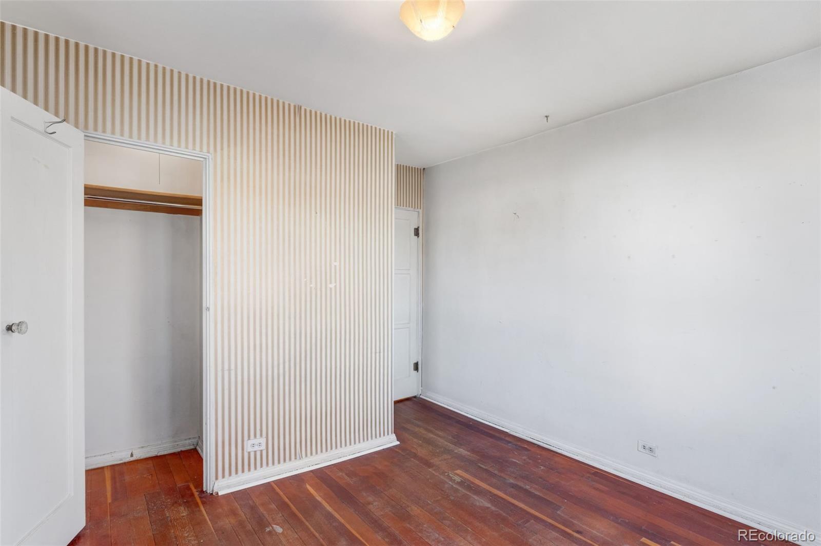 4500 South Washington Street Englewood, CO 80113 - Photo 19 of 30 a view of empty room with wooden floor