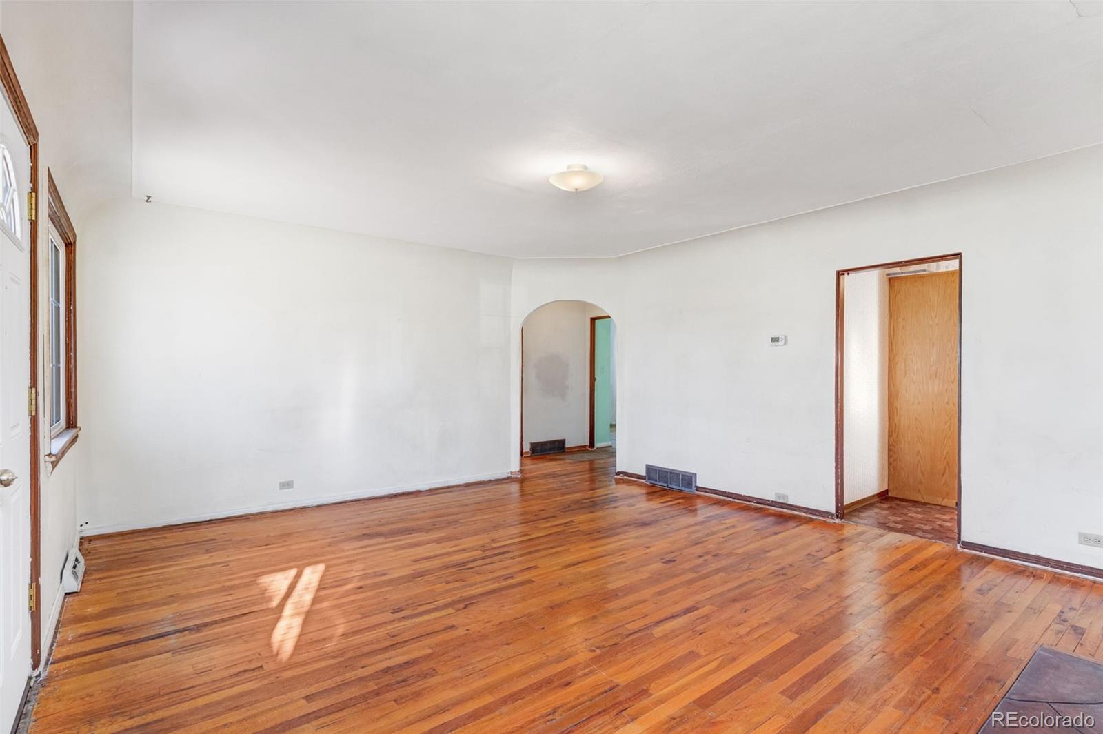 4500 South Washington Street Englewood, CO 80113 - Photo 10 of 30 a view of an empty room with wooden floor