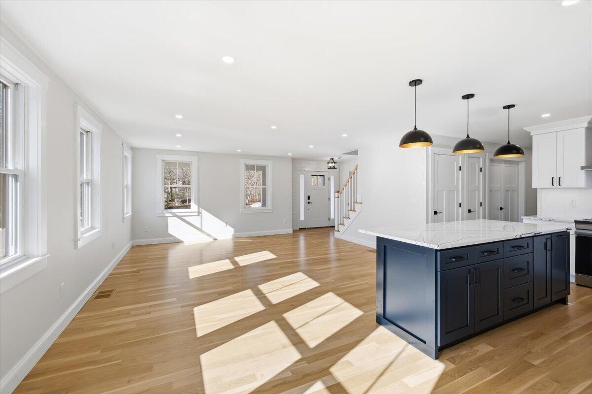 58 Old Chatham Road Brewster, MA 02631 - Photo 7 of 43 a living room with kitchen island furniture and a wooden floor