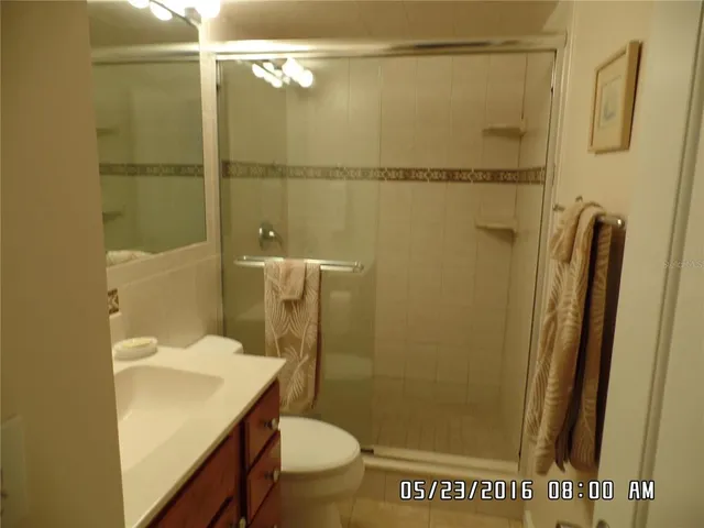 a bathroom with a sink a toilet a shower and a mirror