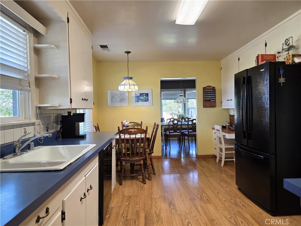 23773 River Road Corning, CA 96021 - Photo 6 of 64 a kitchen with stainless steel appliances granite countertop dining table chairs refrigerator and cabinets