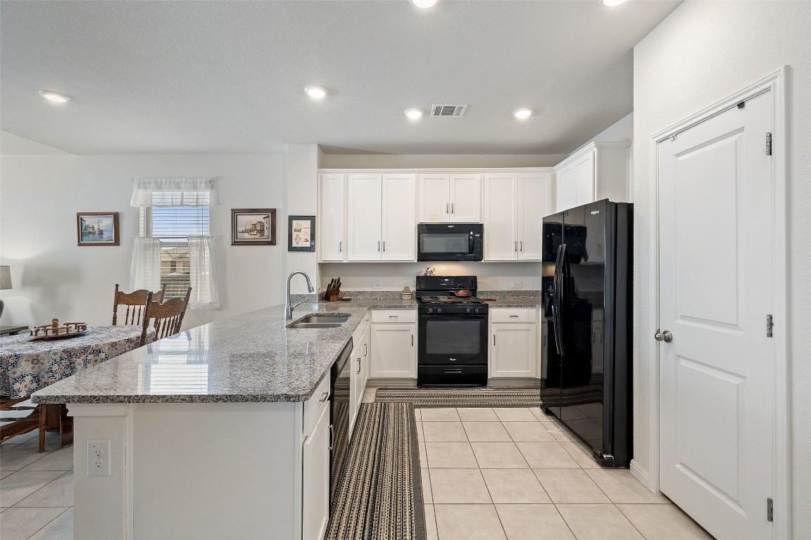 11701 Pecangate Way Manor, TX 78653 - Photo 11 of 40 a kitchen with refrigerator and cabinets