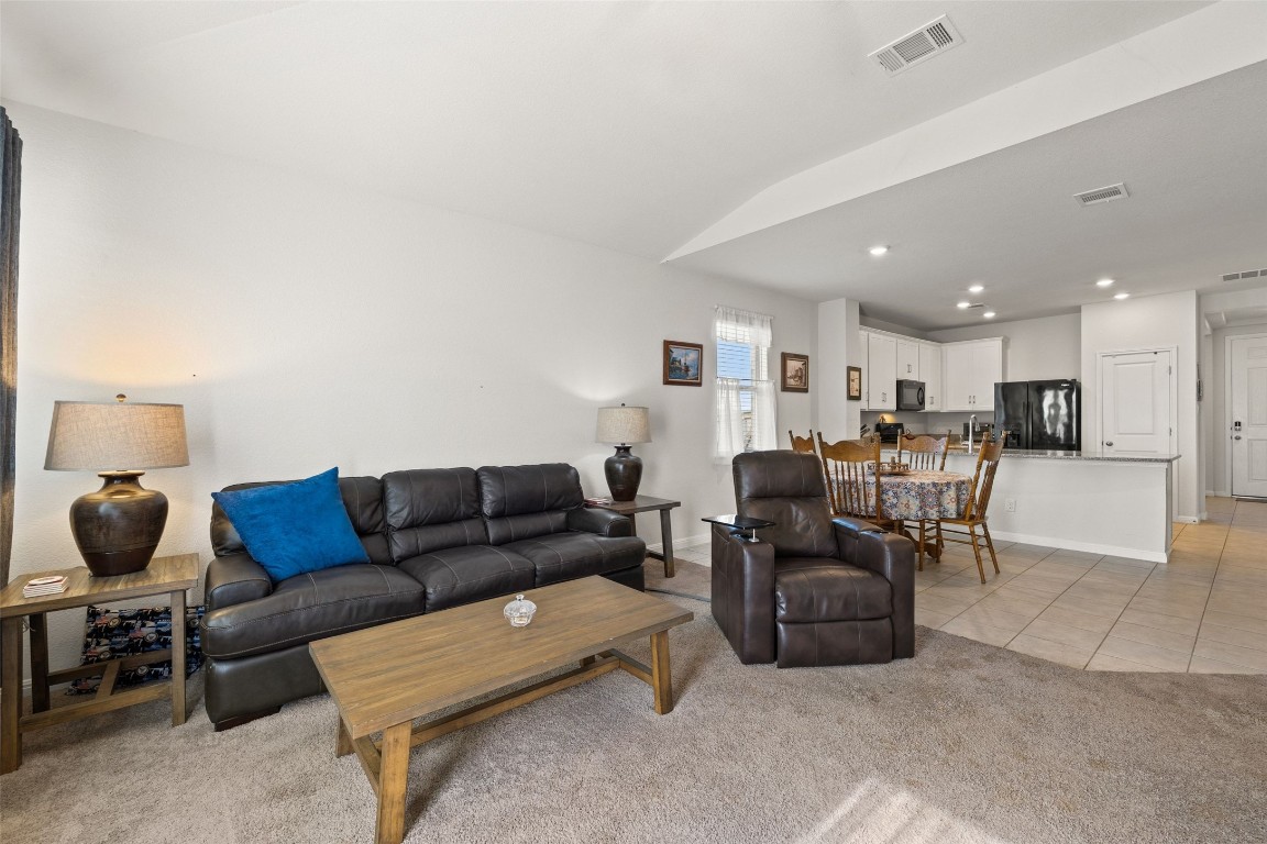 11701 Pecangate Way Manor, TX 78653 - Photo 15 of 40 a living room with furniture and a dining table with kitchen view