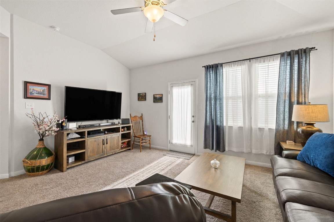 11701 Pecangate Way Manor, TX 78653 - Photo 16 of 40 a living room with furniture and a flat screen tv