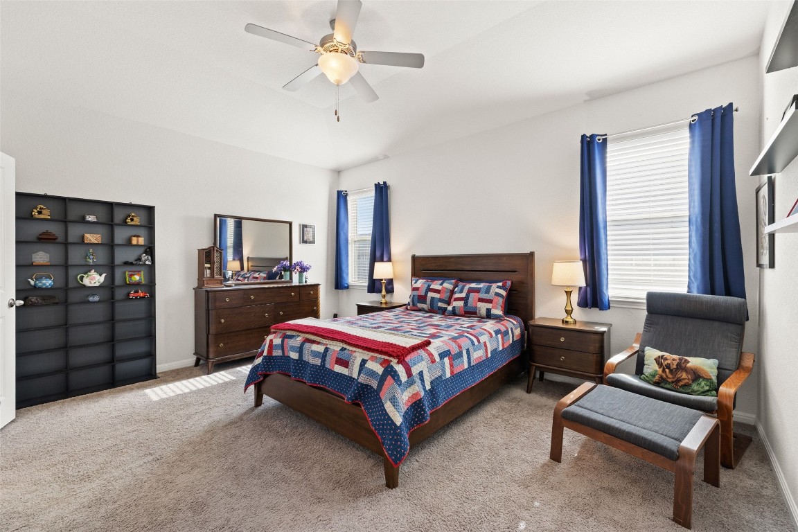 11701 Pecangate Way Manor, TX 78653 - Photo 17 of 40 a bedroom with a bed couch and window