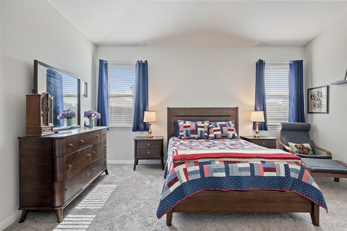 11701 Pecangate Way Manor, TX 78653 - Photo 19 of 40 a bedroom with a bed and a dresser