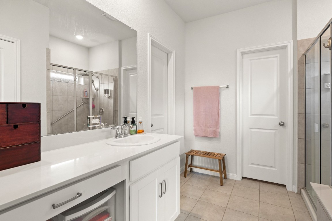 11701 Pecangate Way Manor, TX 78653 - Photo 21 of 40 a spacious bathroom with a sink a mirror and a shower