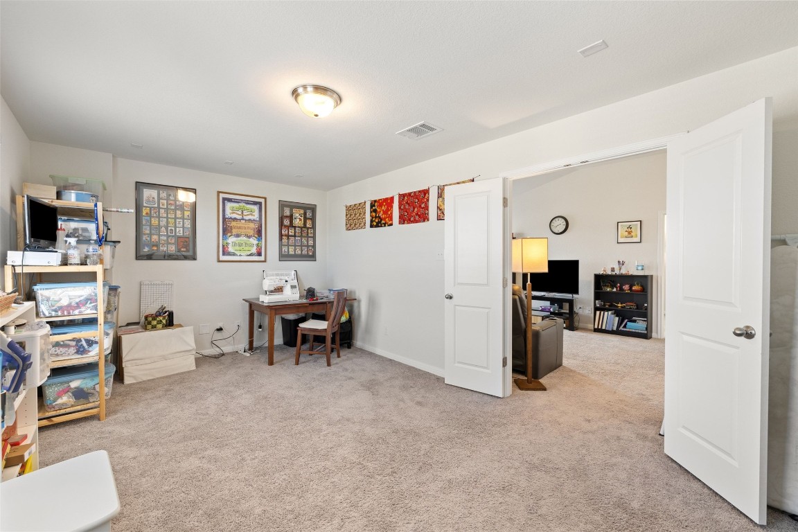 11701 Pecangate Way Manor, TX 78653 - Photo 27 of 40 a living room with furniture and a flat screen tv