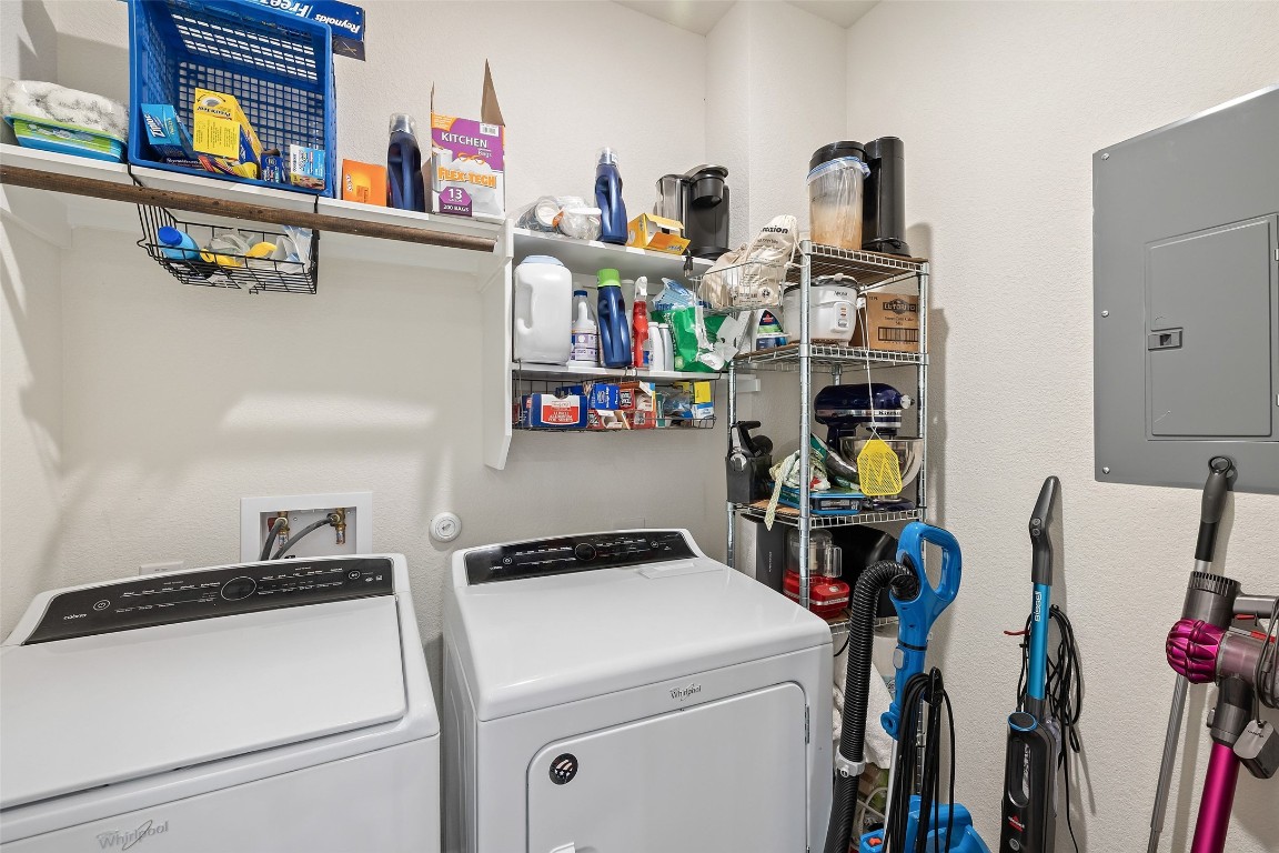 11701 Pecangate Way Manor, TX 78653 - Photo 33 of 40 a view of storage and utility room with washer and dryer