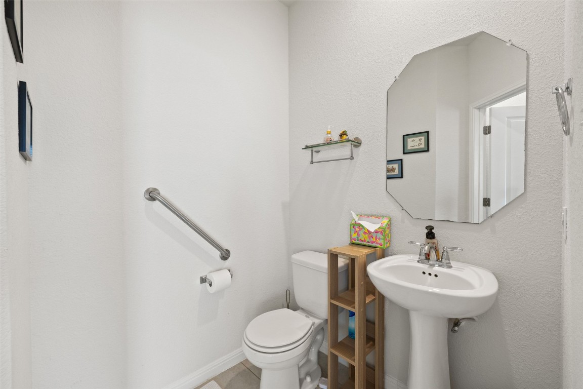 11701 Pecangate Way Manor, TX 78653 - Photo 34 of 40 a bathroom with a sink toilet and a mirror