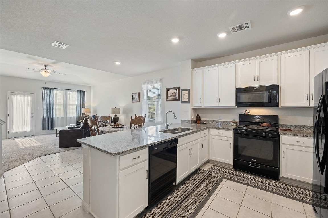 11701 Pecangate Way Manor, TX 78653 - Photo 9 of 40 a kitchen with a sink stove and cabinets