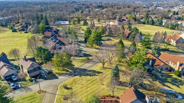 an aerial view of residential houses with outdoor space