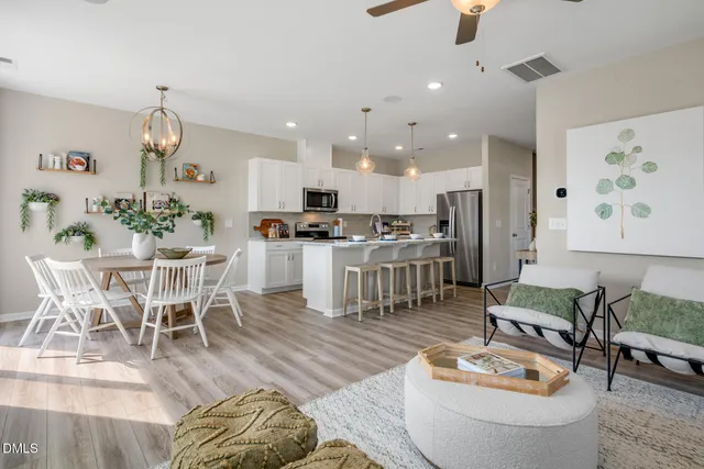 a living room with furniture and kitchen view