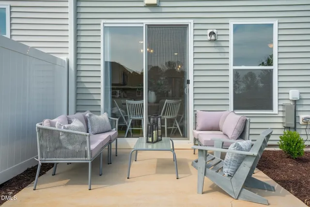 a outdoor living space with patio furniture and potted plants