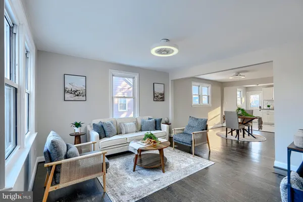 a living room with furniture and wooden floor